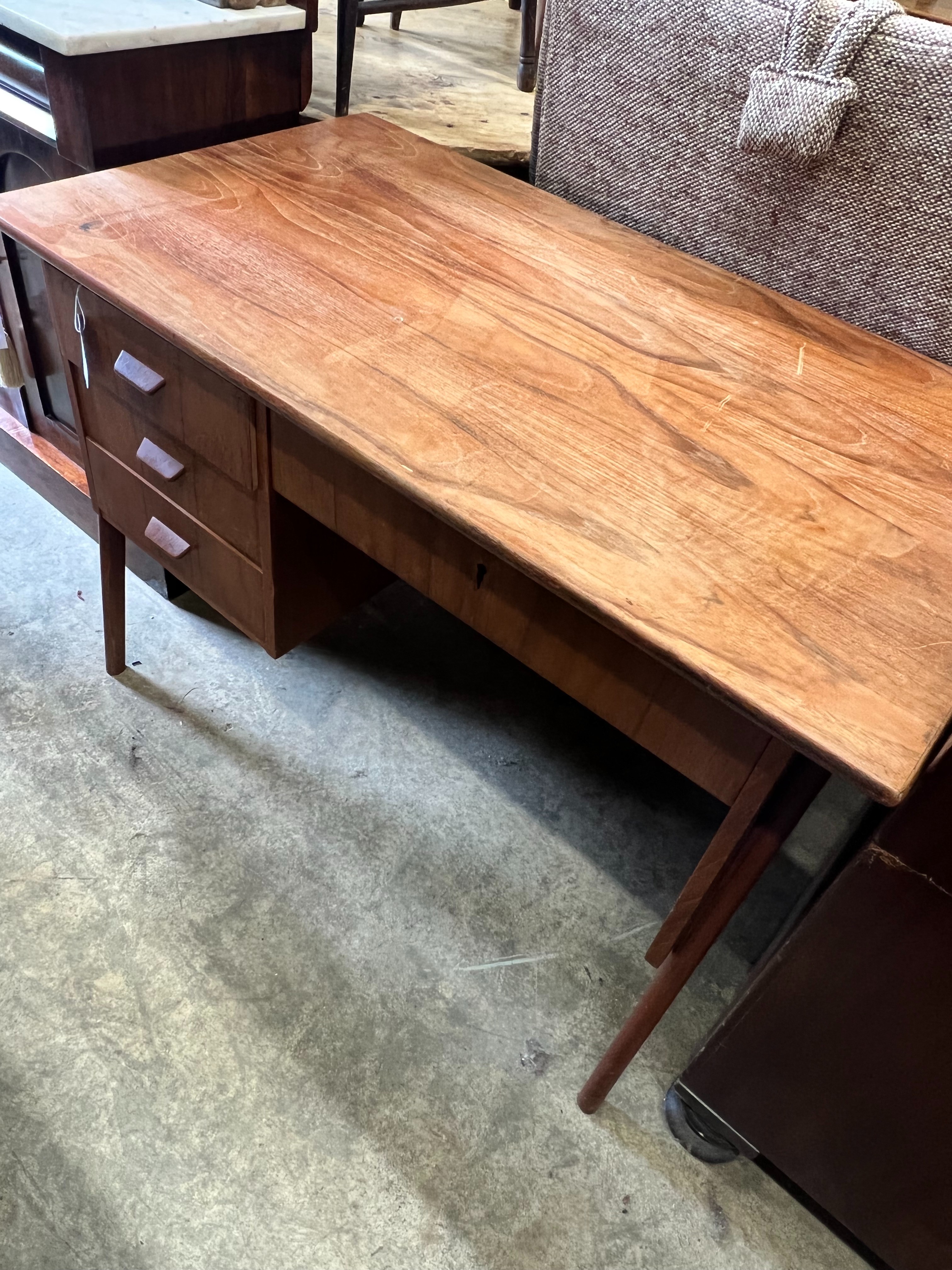 A mid century Danish style teak kneehole desk, width 105cm depth 59cm height 73cm